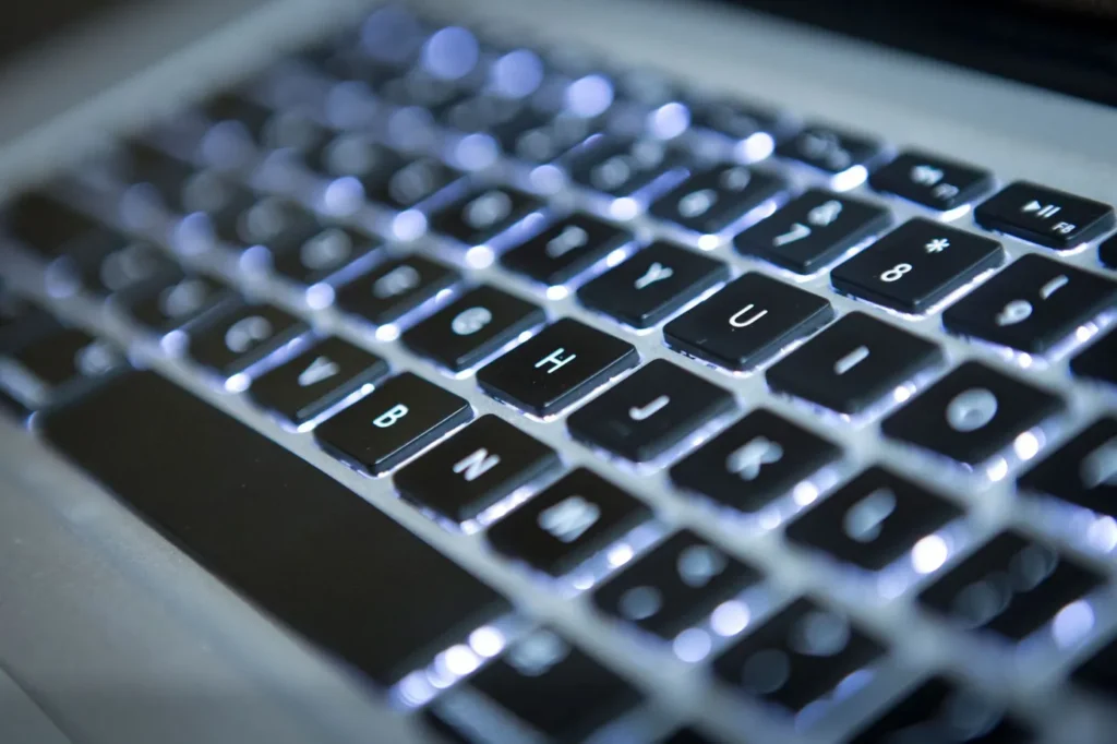 Computer keyboards with assignable keys and characters that are lit up rather than printed on